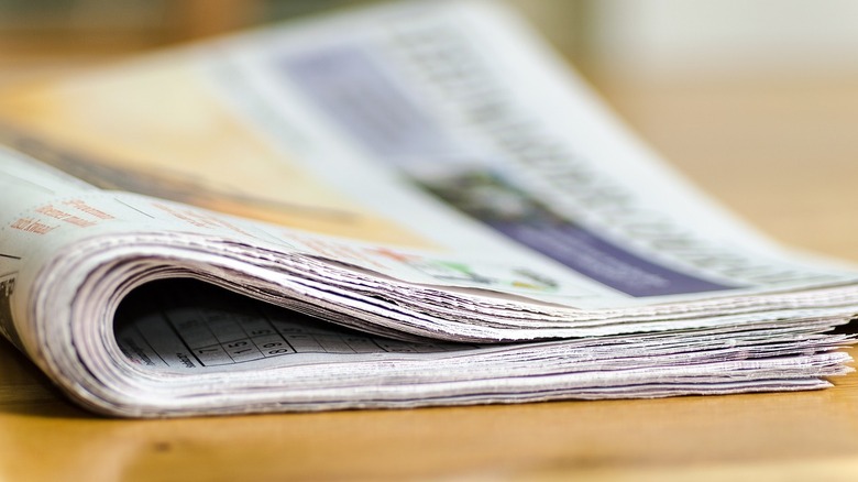 rolled up newspaper on ground