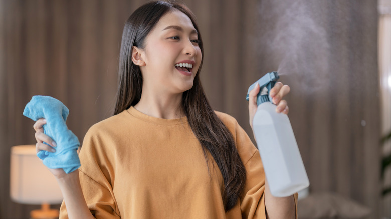 Woman test sprays cleaning solution