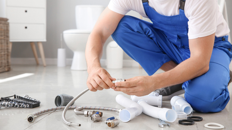 Plumber organizing toilet parts