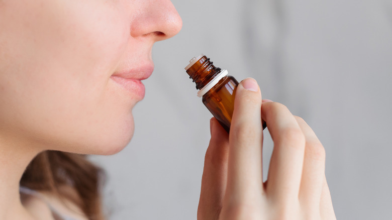 A woman smelling essential oils