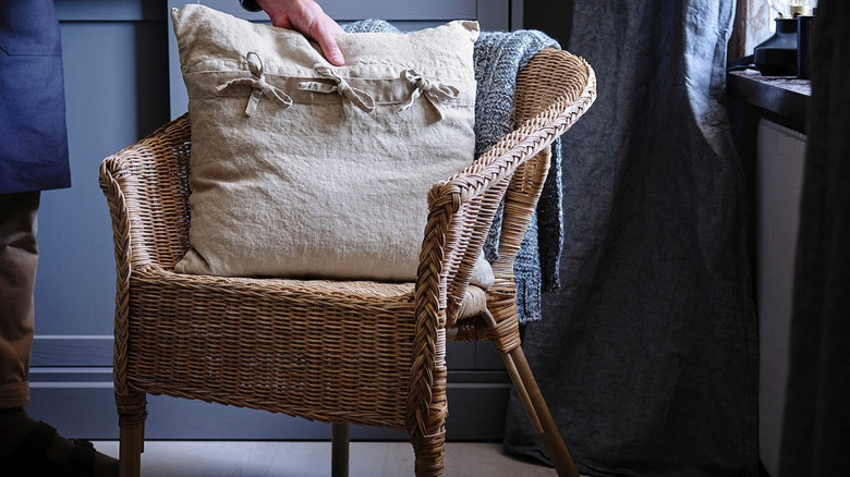 Fluffing pillow on a rattan chair