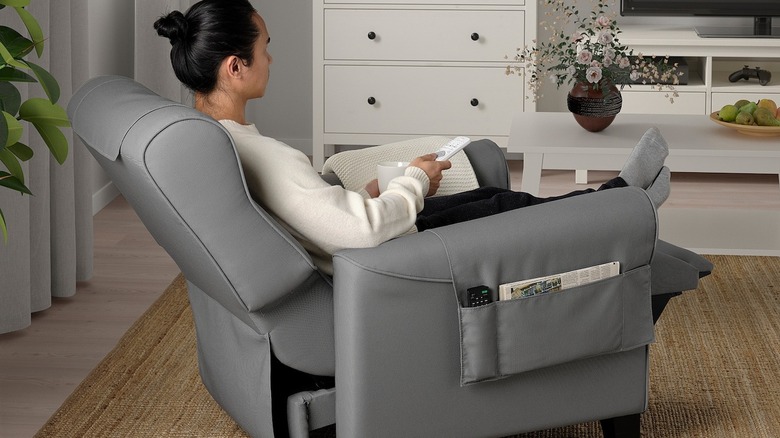 Person sitting in large gray recliner