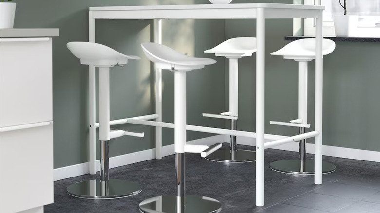 four white adjustable bar stools