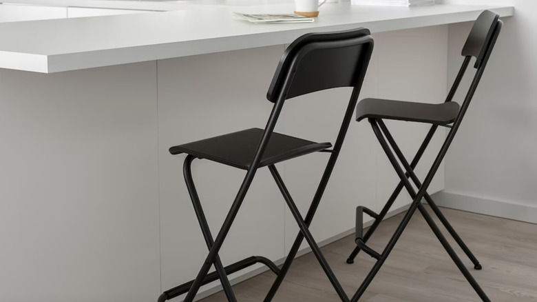 two black foldable bar stools