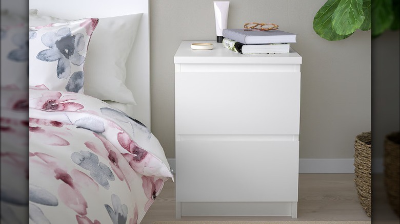 White nightstand next to bed