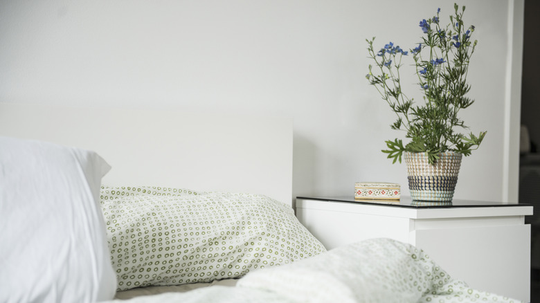 White bed with nightstand