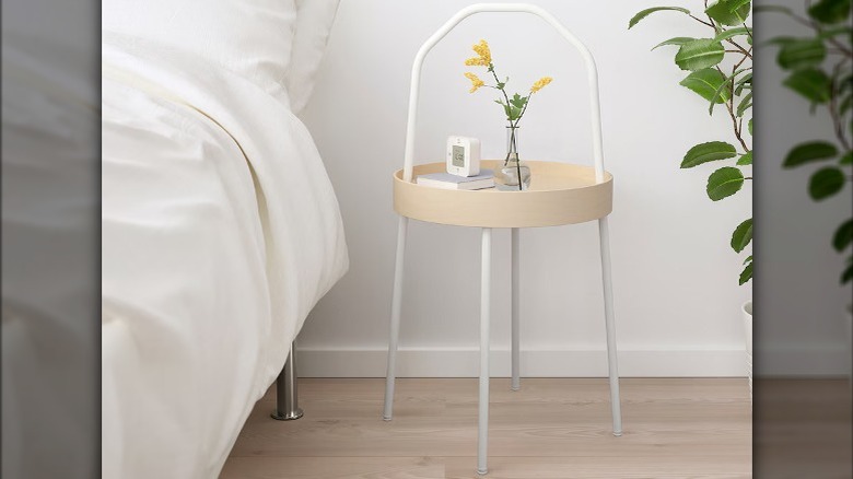 wooden bedside table next to bed