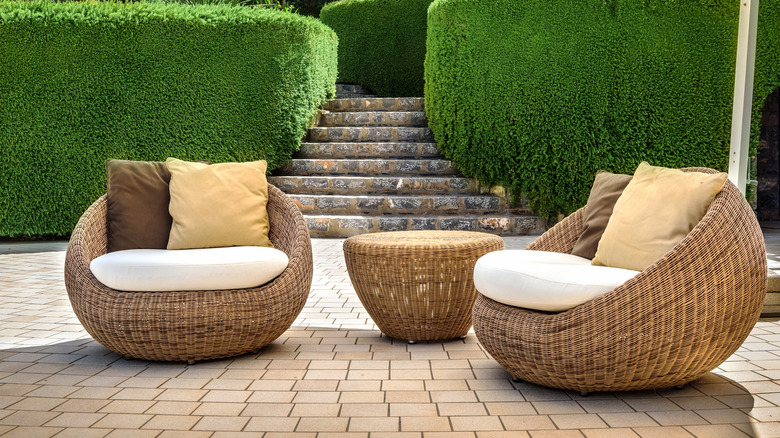 Backyard area with rattan chairs.