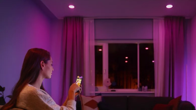 Woman adjusting lighting in room