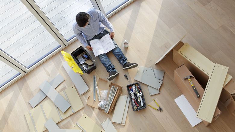 Person assembling IKEA furniture.