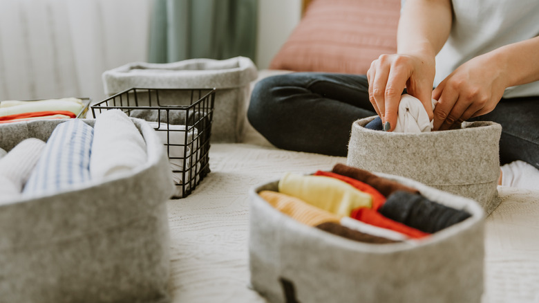 person preparing storage bins