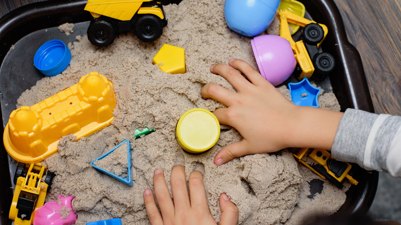 child playing in sensory box 