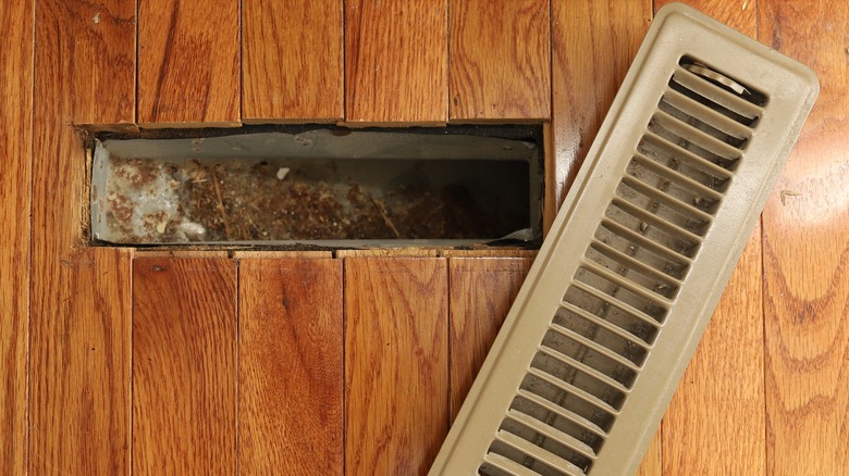 dirty floor vent with debris