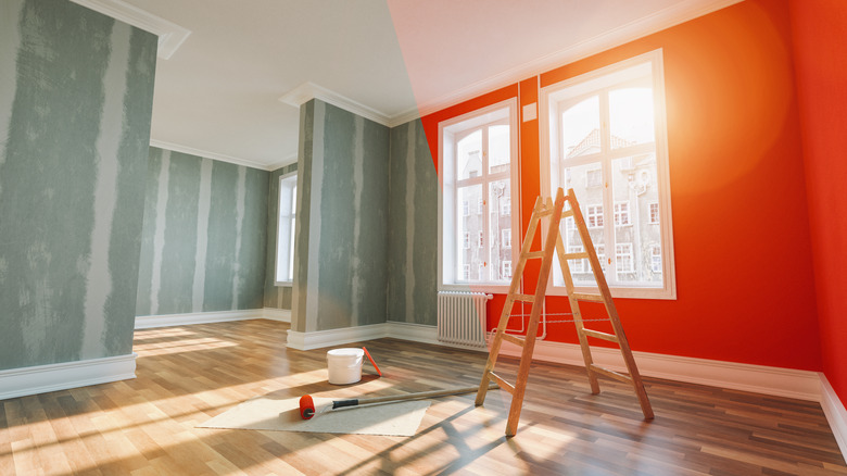 half painted room with ladder