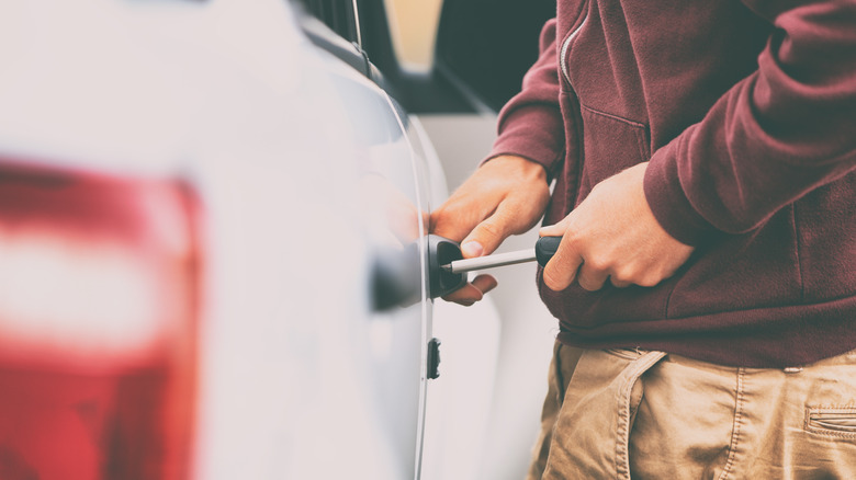 thief breaking into a car