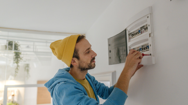 man testing circuit breaker