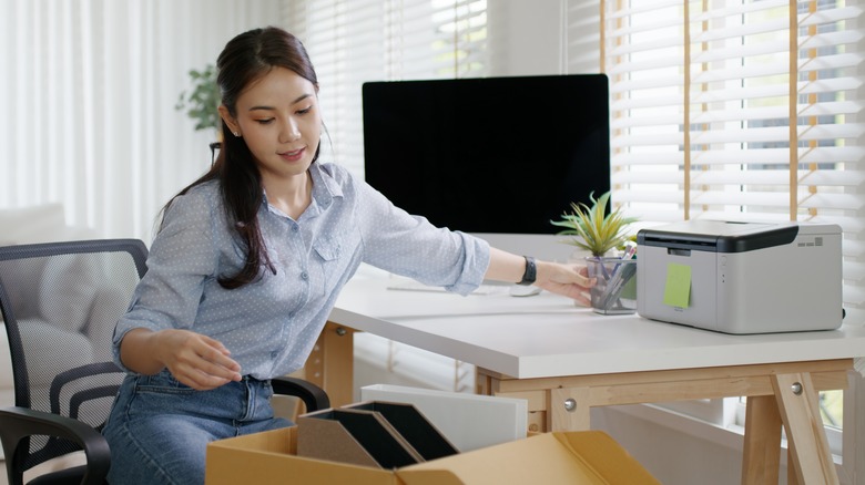 Woman organizing home office desk