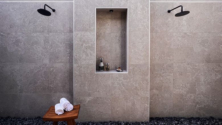 A large shower with bench