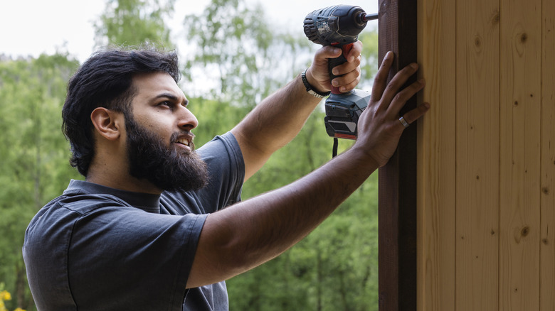 man installing a fence