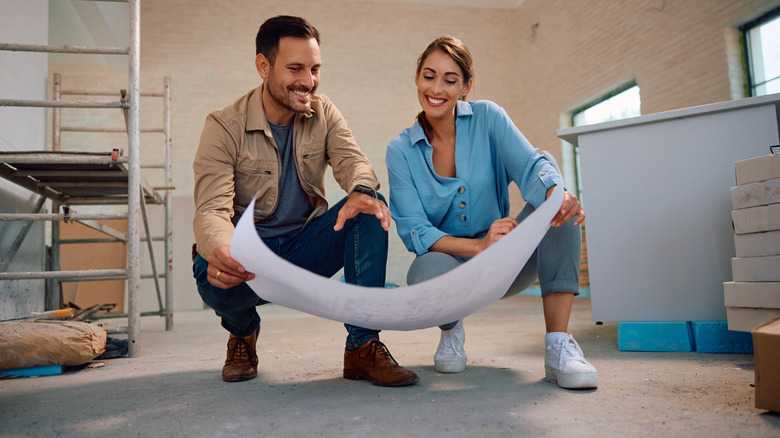 Couple looking at floorplans