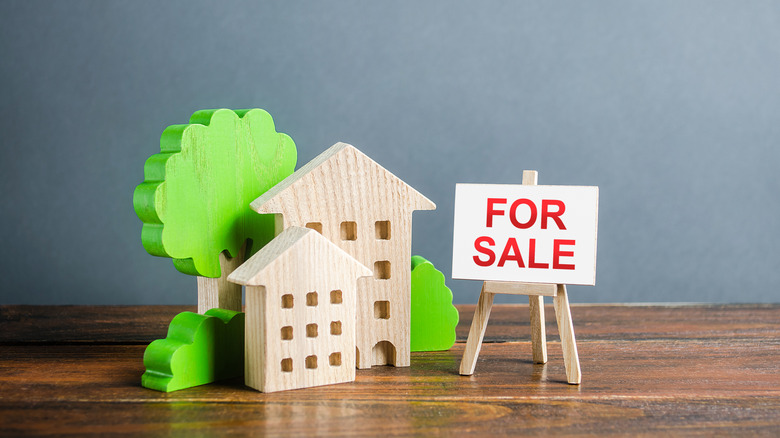 Toy houses and for sale sign
