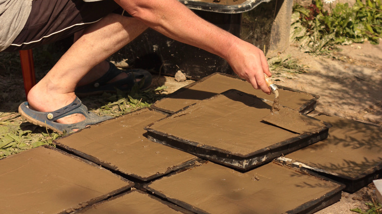 man making concrete tiles