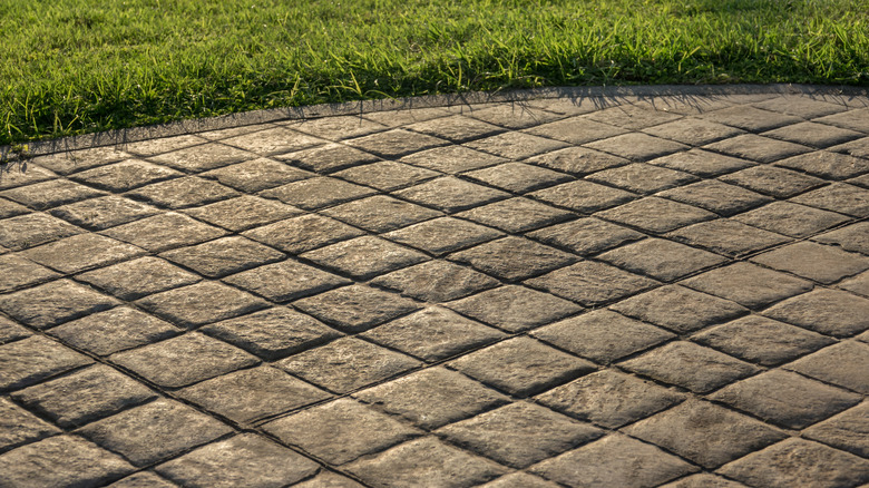 concrete stamped patio with grass