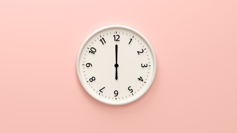 white clock on pink wall