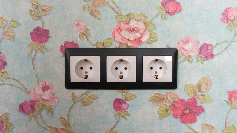 white outlets on floral wall