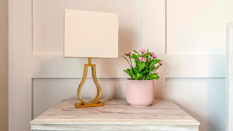 lamp next to potted flowers