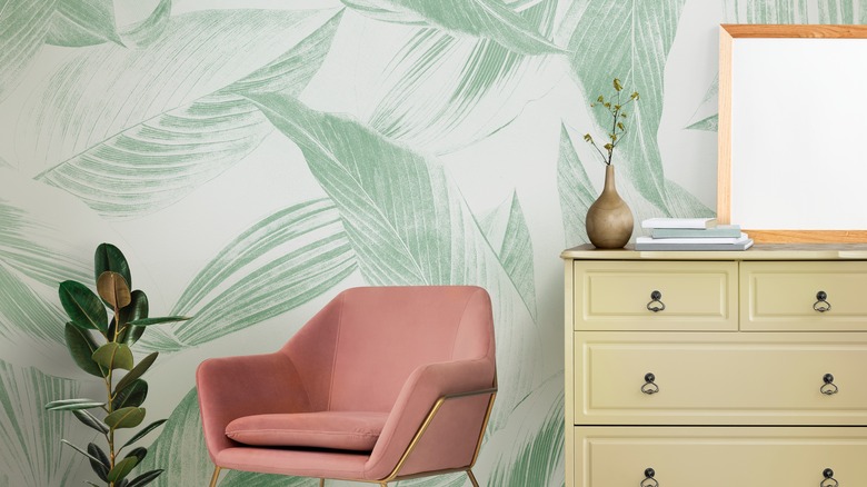 green wallpaper on wall with chair