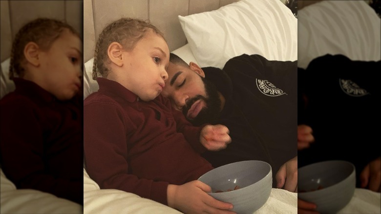 Drake lounging with his son in bed