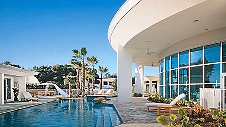 Backyard pool, slide, and airplane hangar