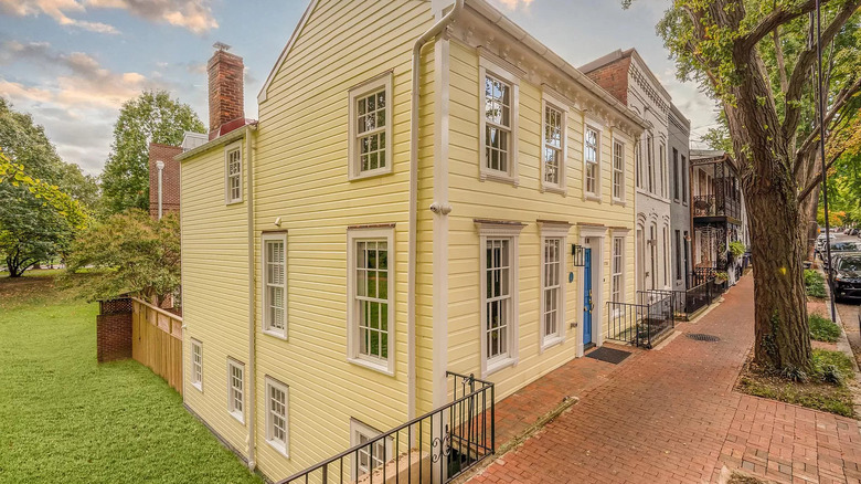 Yellow home on brick street