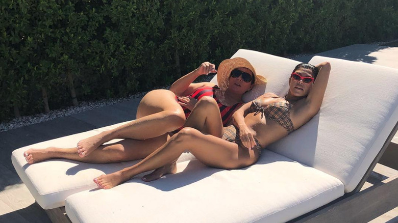 Kourtney Kardashian and Kris Jenner lounging outdoors