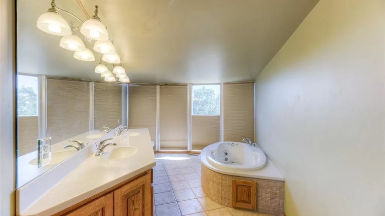 bathroom with tub and lights