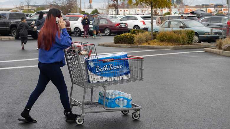 Woman walking with a Costco shopping cart