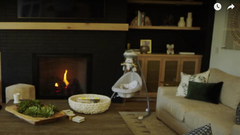 living room with dark brick fireplace