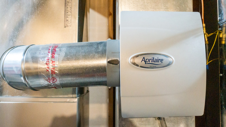 A whole house dehumidifier installed in an attic