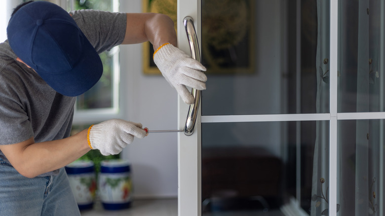 A professional installing an aluminum security door