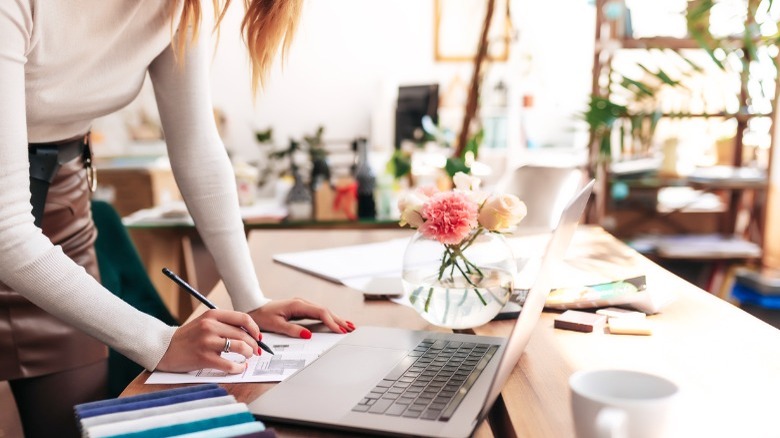 Woman standing at desk 