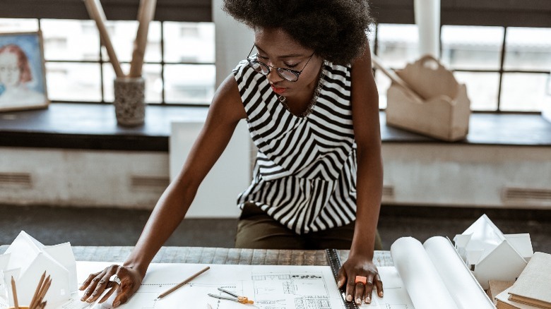 Woman looking at blueprints