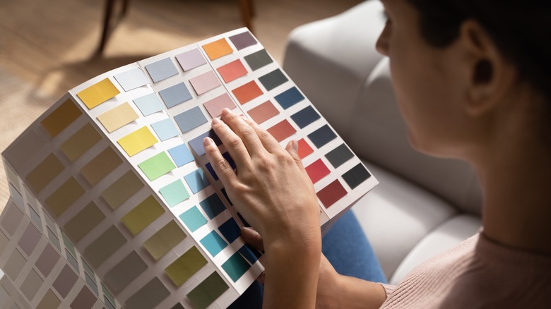 Person deciding with color swatch