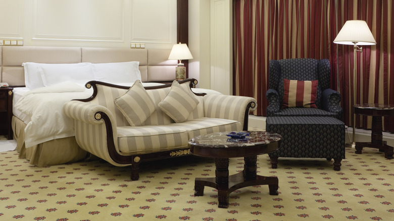 neutral striped settee in bedroom