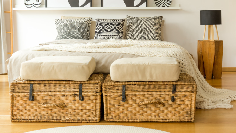 two woven trunks by bed