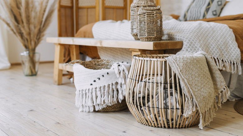 baskets holding blankets in bedroom