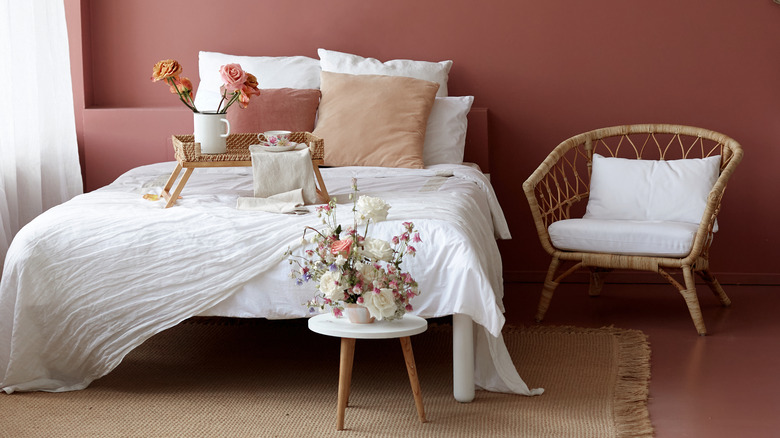 marble stool with flowers by bed