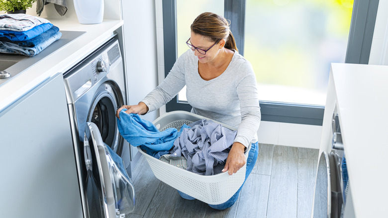 woman loading a washing machine