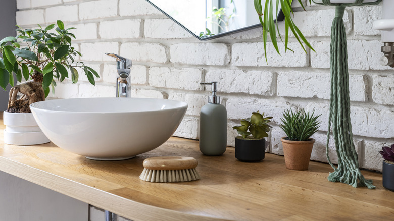 An attractive bathroom vanity with a wood countertop