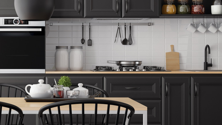 Kitchen with black cabinetry and accents